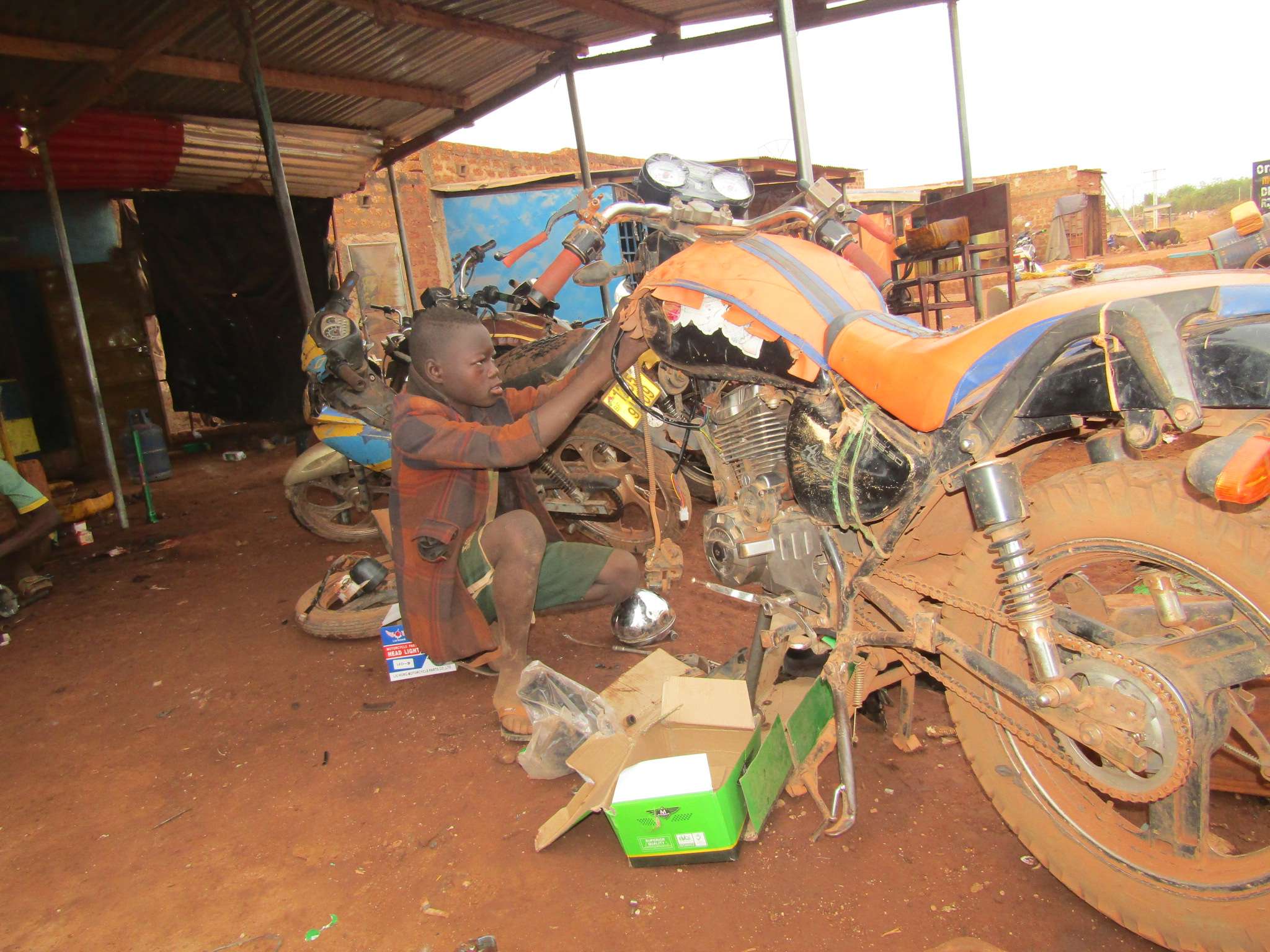 A beneficiary learning motorcycle mechanics
