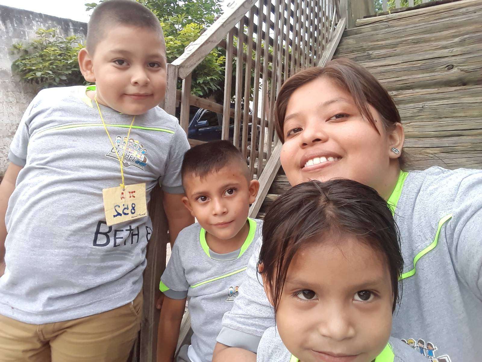 Happy children with their tutor at the playground