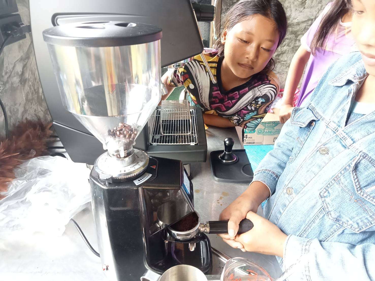 Youngsters practicing coffee making skills.