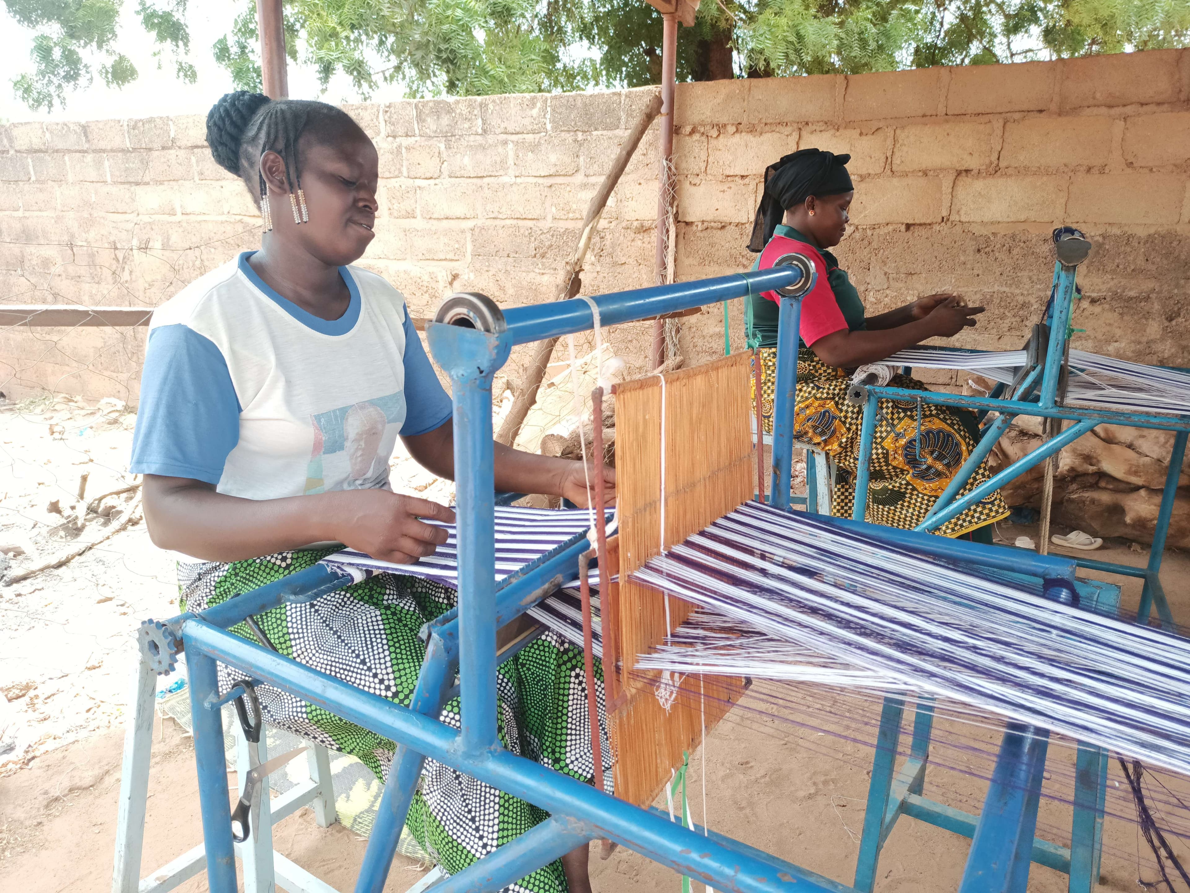 Two women weaving loincloths