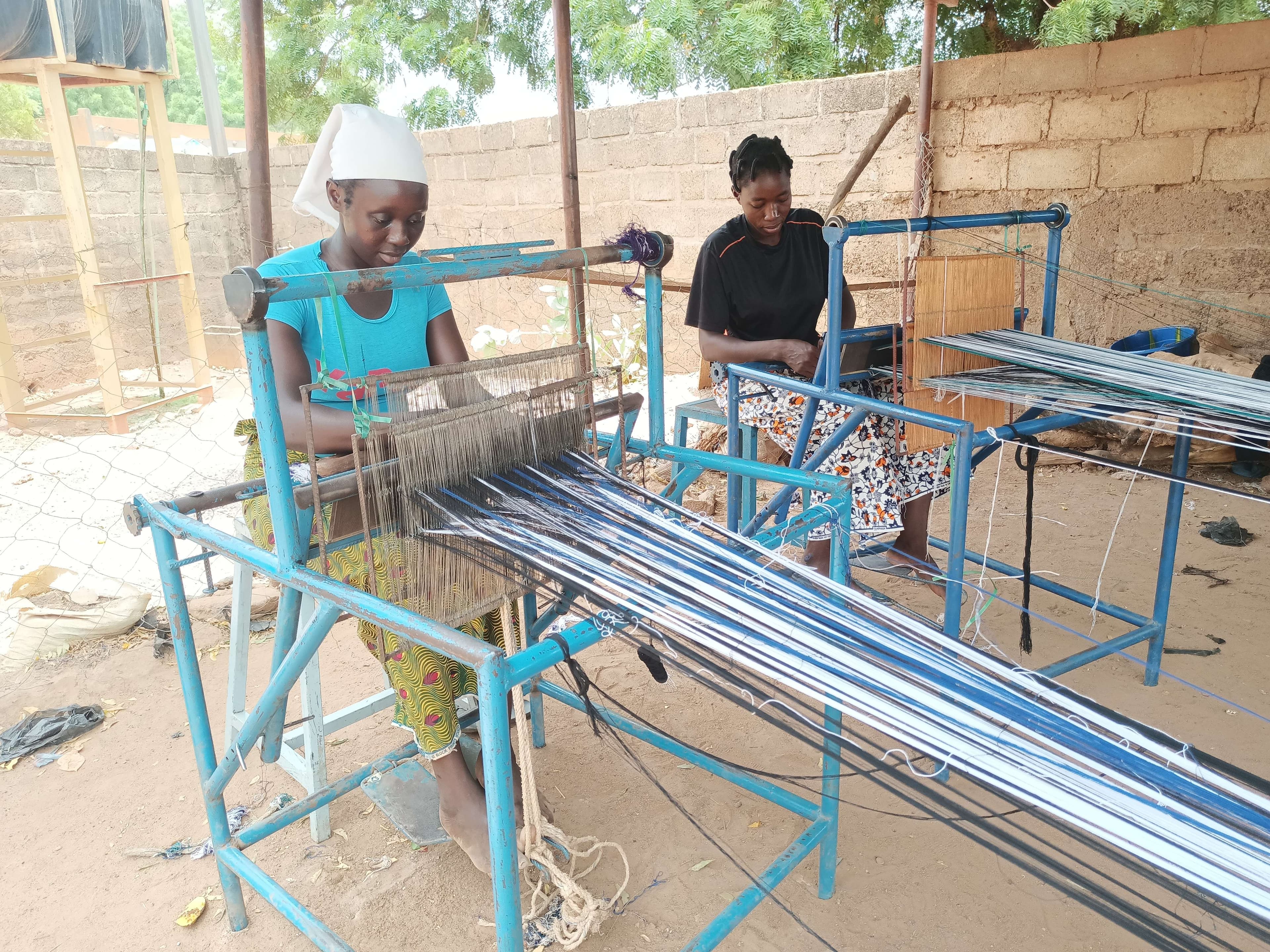 Two women weaving loincloths