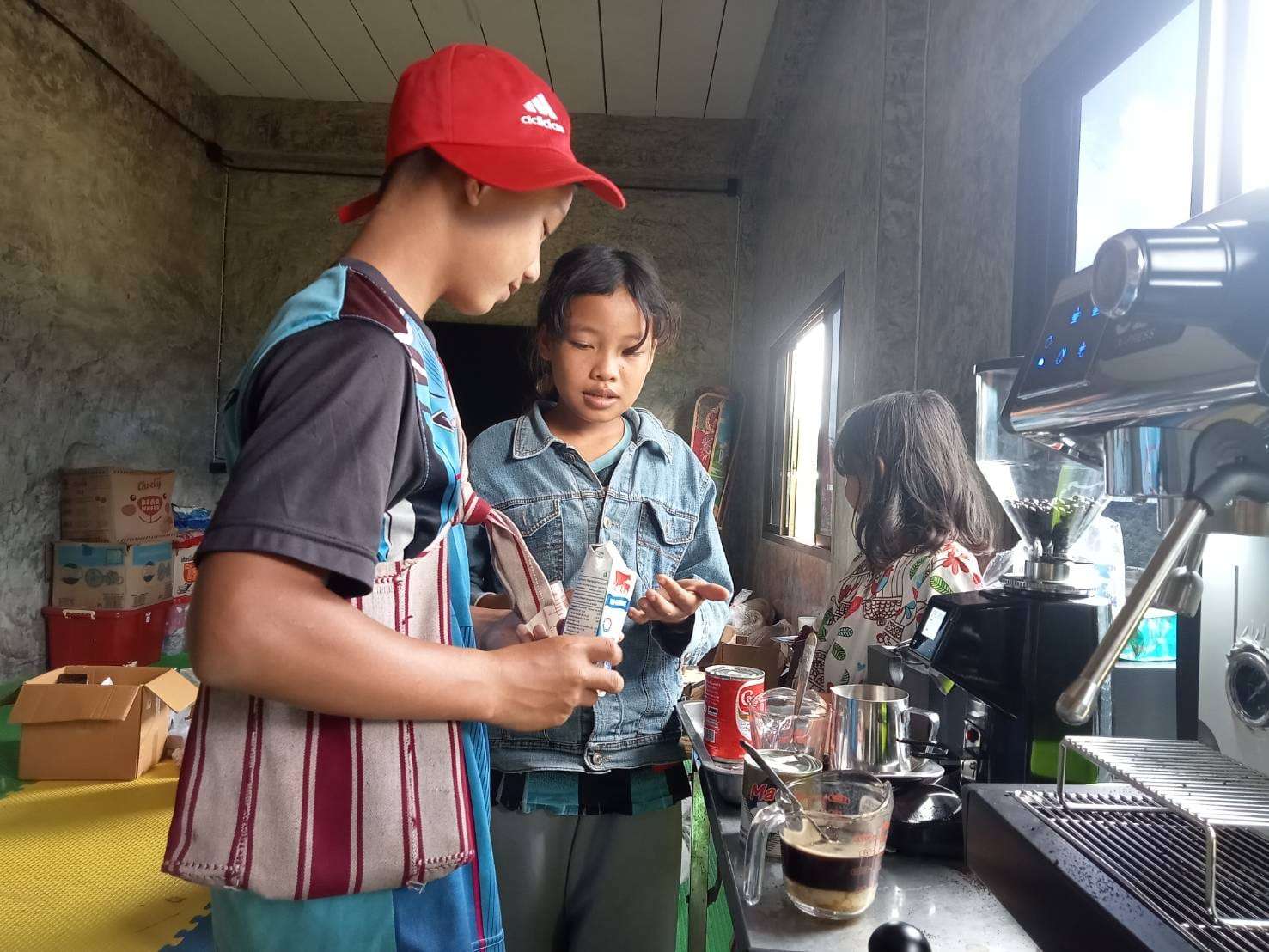 Youngsters practicing coffee making skills.