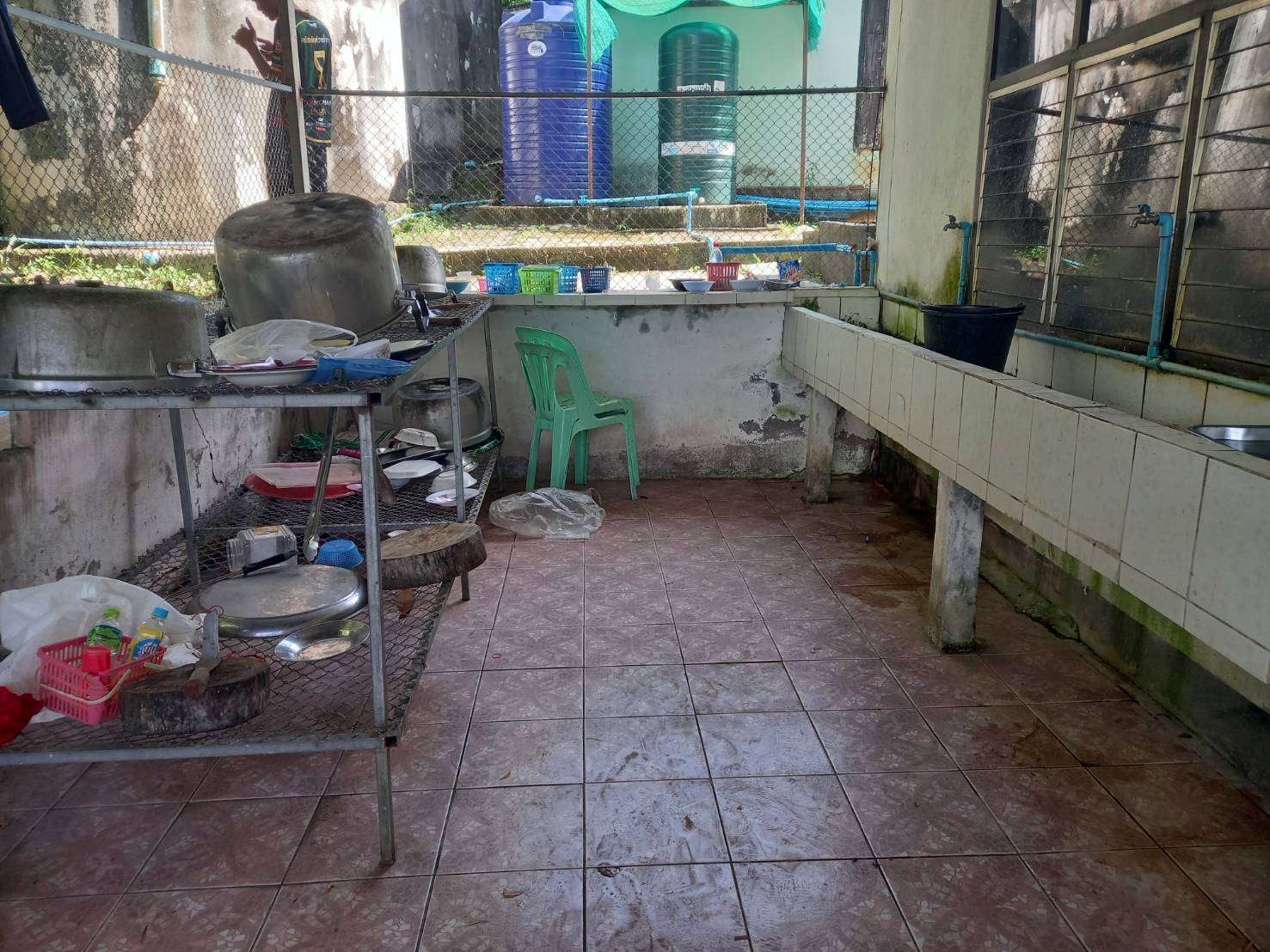 The sink and soap and toothpaste storage are near the storage.