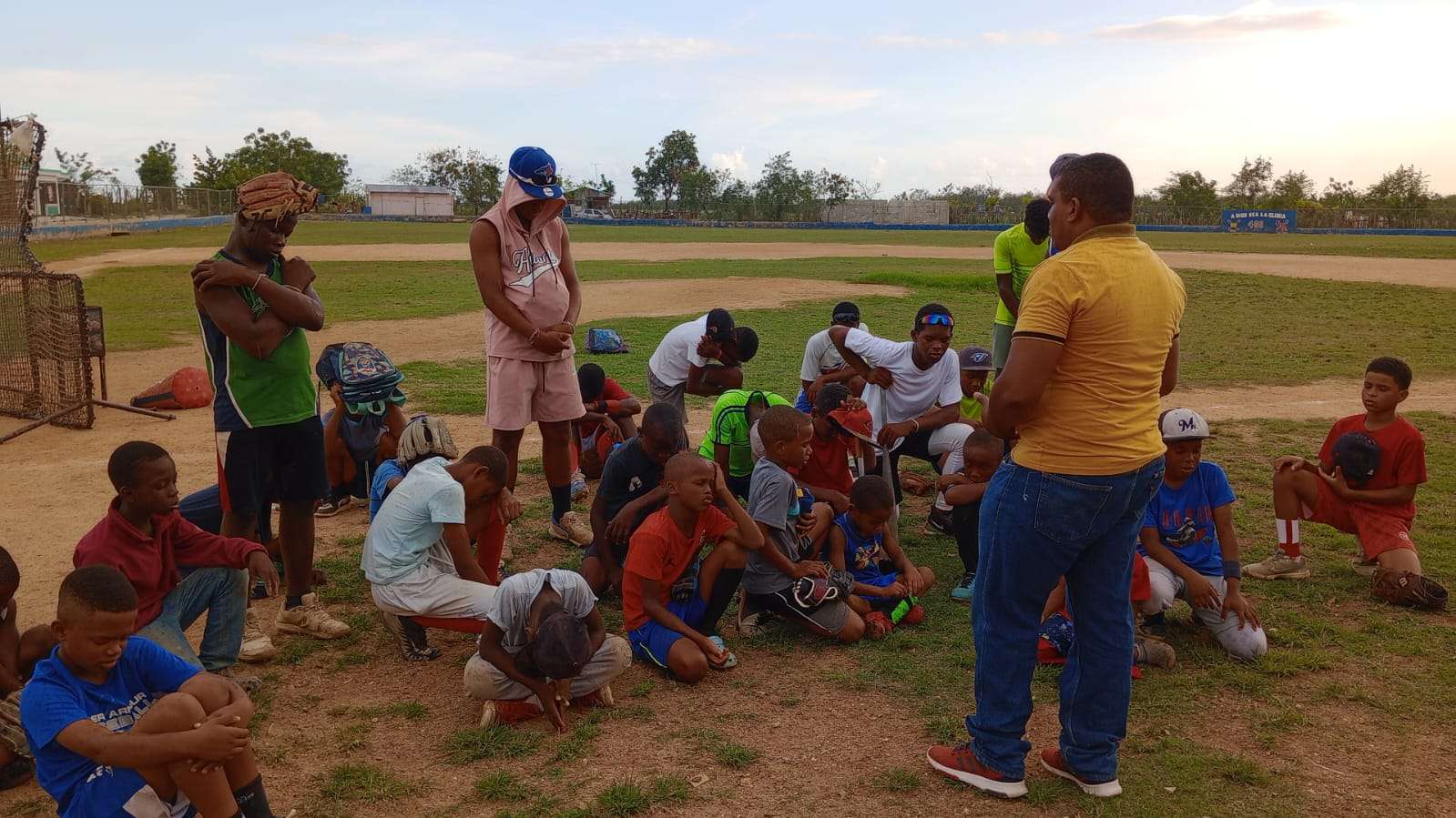 Prayer and teaching by the pastor with the children.