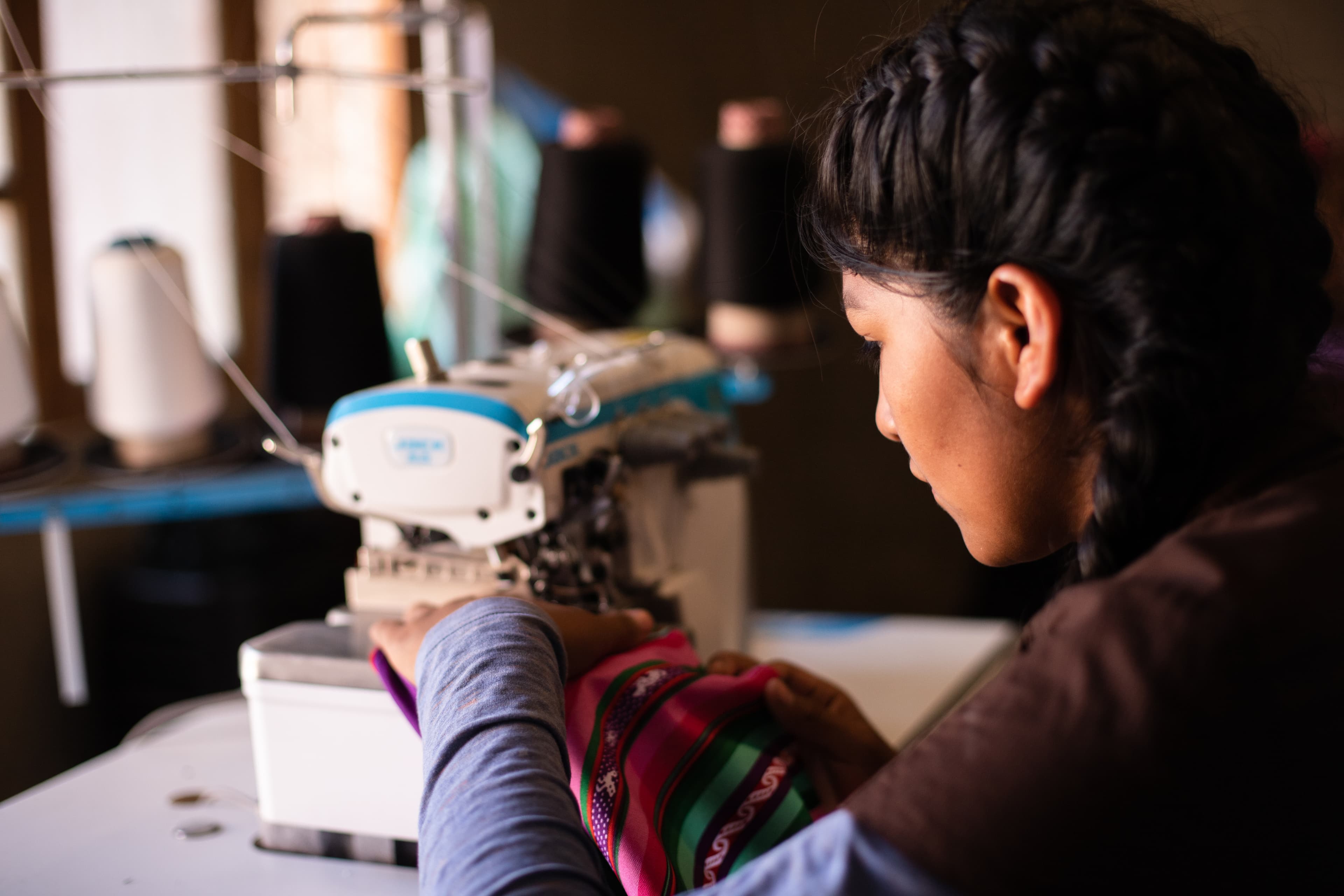 a child learning to sew